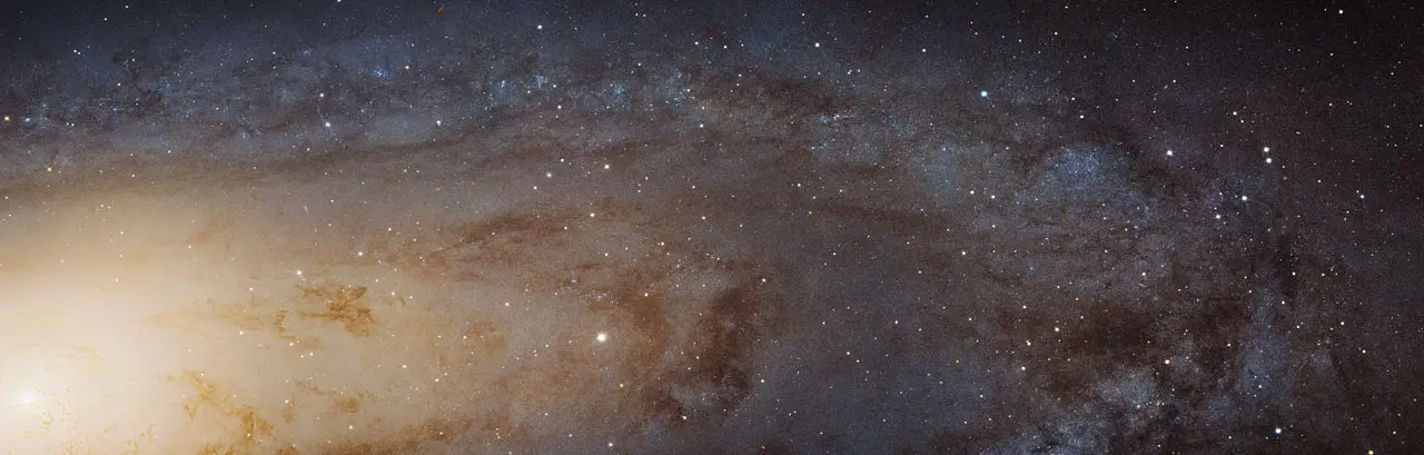 The sharpest ever view of the Andromeda Galaxy: a vast tilted spiral resolved into a haze of individual stars, threaded with dark dust lanes.