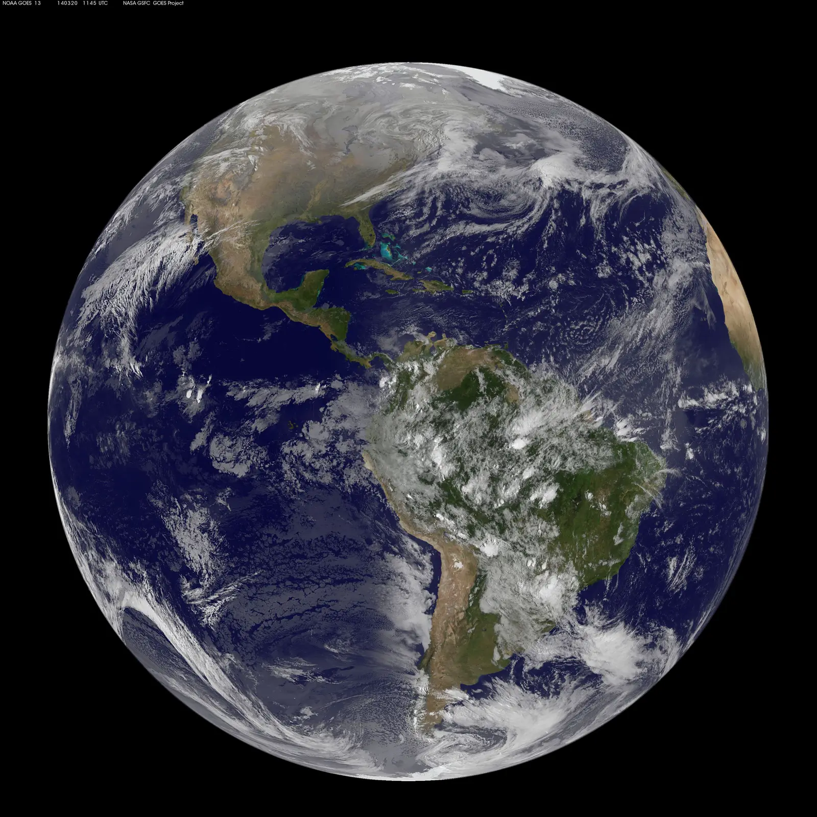 A full-disc view of Earth from geostationary orbit: the whole Americas hemisphere in one frame, cloud systems sharp against blue ocean.