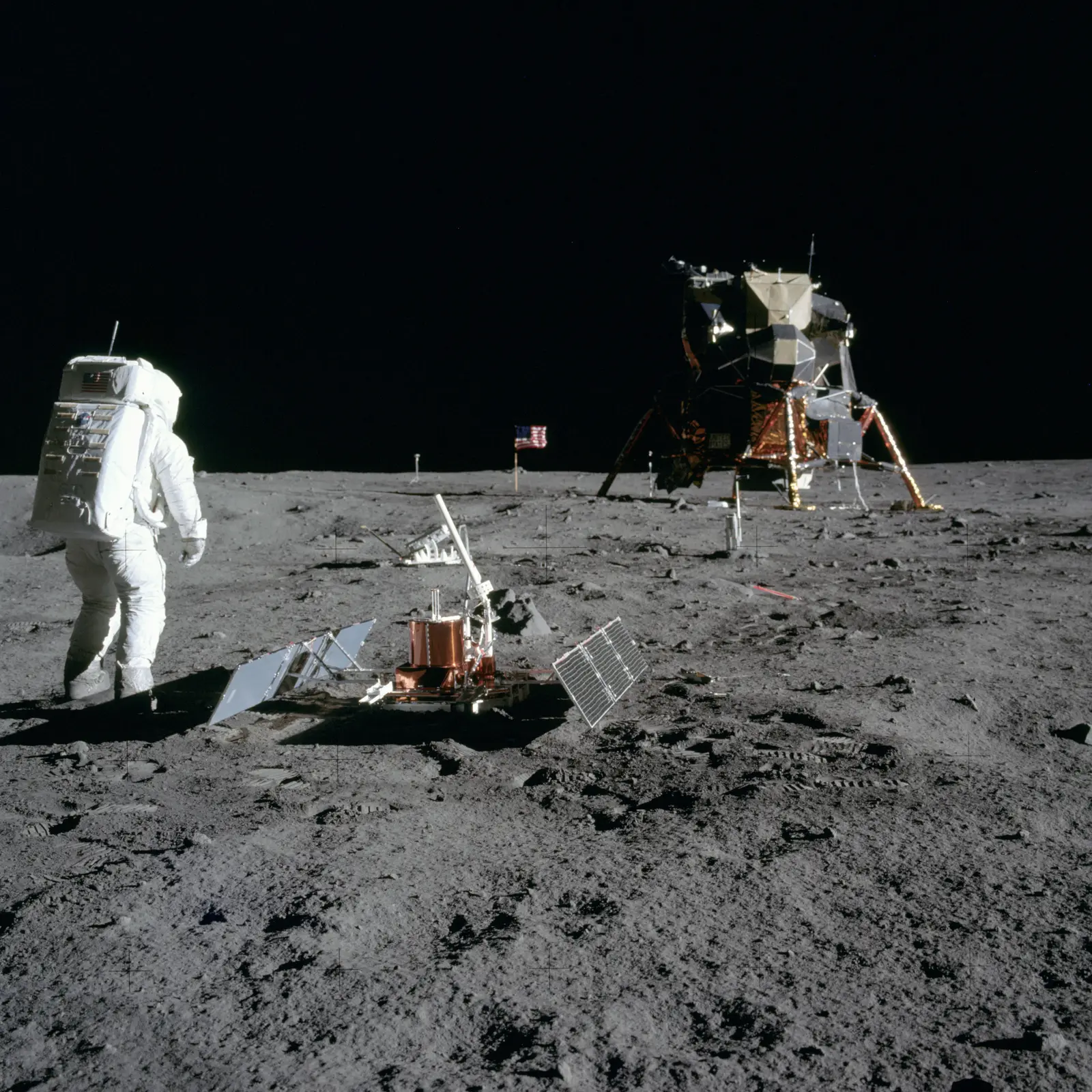 Buzz Aldrin standing on the lunar surface beside the just-deployed Early Apollo Scientific Experiments Package, which includes the laser ranging retroreflector still in use today.