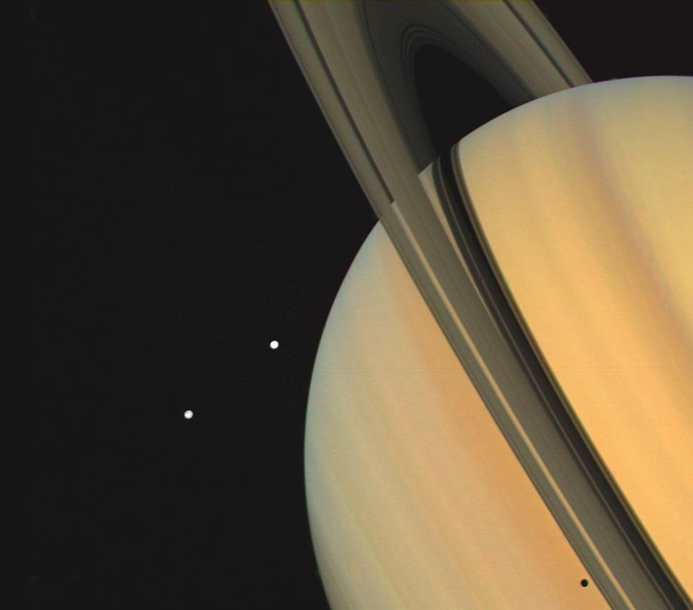 Voyager 1 view of Saturn with Tethys and Dione.
